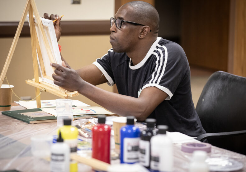 Patient Sekou Toure works on a painting during a Recovery Art Workshop at Vanderbilt Psychiatric Hospital. (photo by Erin O. Smith)