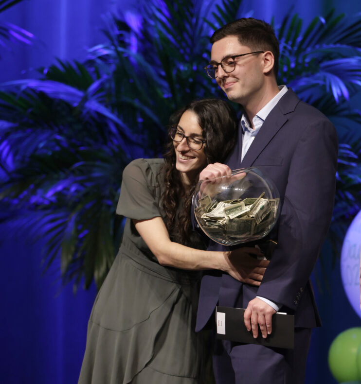 Jessica McDonald and Alex Bruno hold the fishbowl of dollar bills they received for having their names called last. The couple will stay at VUMC for their residencies in pathology and pediatrics, respectively. (photo by Donn Jones)