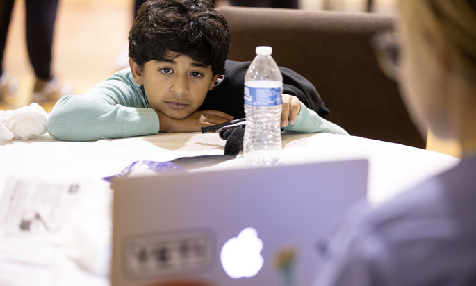 Markos Lewis, 10, watches a presentation. (photo by Erin O. Smith)