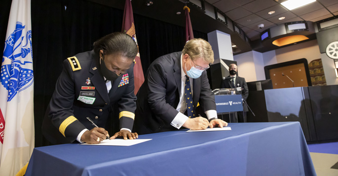 Maj. Gen. Telita Crosland and C. Wright Pinson, MBA, MD, sign the agreement for VUMC to become an official site of the U.S. Army Military-Civilian Trauma Team Training.