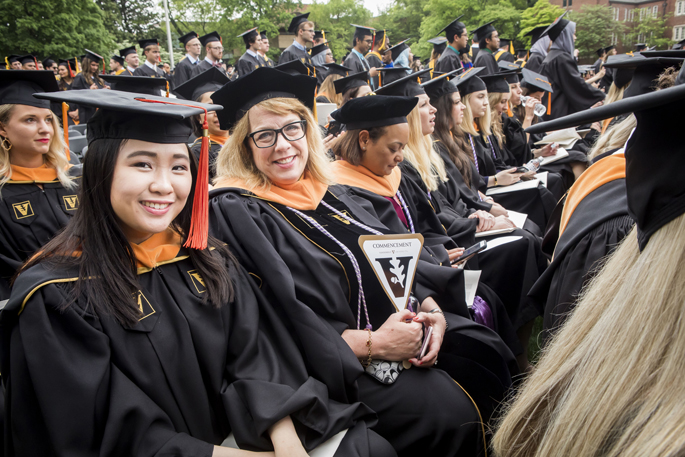School of Nursing MSN graduate Mary Ann Enriquez, left, DNP graduate Marci Zsamboky and classmates gather for the main ceremony.