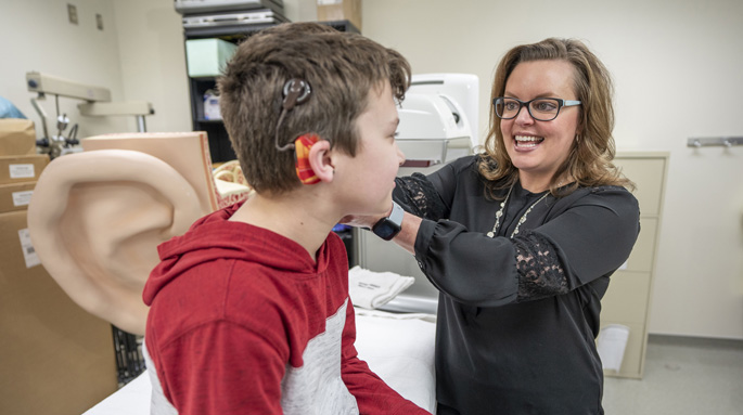 Rene Gifford, PhD, works with patient Davy Hillis to program his cochlear implant. 