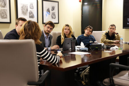 Visiting Ukrainian surgeons review the transplant schedule with Dawn Eck, ACNP-BC, MMHC, NEA-BC.