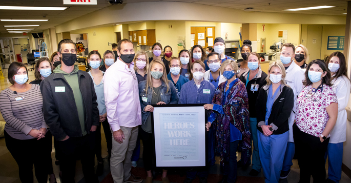 The Eitl family poses with the plaque the family donated to thank the transplant team for taking care of Joe Eitl, who received a heart and liver transplant last year.