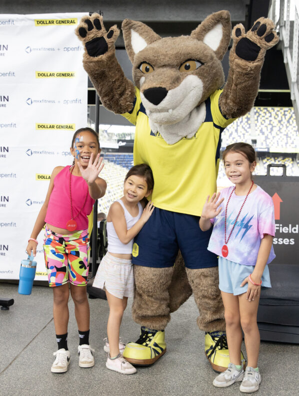 Kyree Hughes, left, Mercedes Low, center, and Lilian Low with Nashville SC mascot Tempo. (photo by Erin O. Smith)