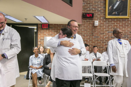 Nike Izmaylov gives Balser a hug after receiving her coat.
