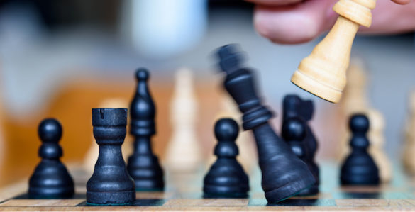 chess player knocking over opponents king