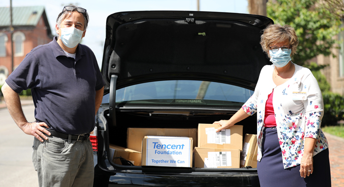 Metro vice mayor Jim Shulman and Dena McCormick, vice president of Vanderbilt Health Purchasing Collaborative, pose for a photo with boxes of masks being donated to Vanderbilt University Medical Center after packing the masks into a car at a temporary storage location on Monroe Street Monday, May 4, 2020 in Nashville, Tennessee. The Ferrell McDaniel Company donated thousands of masks to Vanderbilt University Medical Center.