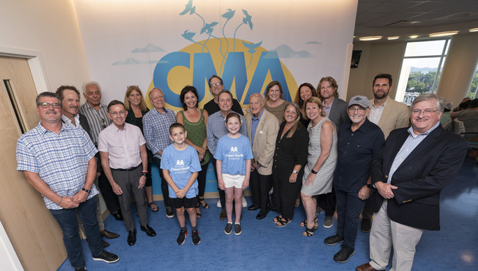 Monroe Carell Jr. Children’s Hospital at Vanderbilt patients Cooper Cook (center, left) and Grace Hamilton (right) give CMA and CMA Foundation board members a tour of CMA’s newly named space within the hospital’s expansion.