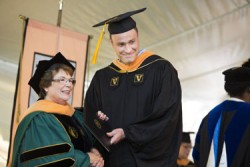 School of Nursing Dean Linda Norman, DSN, R.N., congratulates Will Carpenter at Friday’s ceremony. (photo by Susan Urmy)