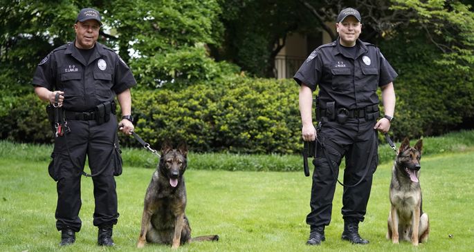 VUPD officer Sgt. Eddie Lawler and his K-9 companion Akali and Sgt. Joe Musick and Kato pose for a photo at VUMC.