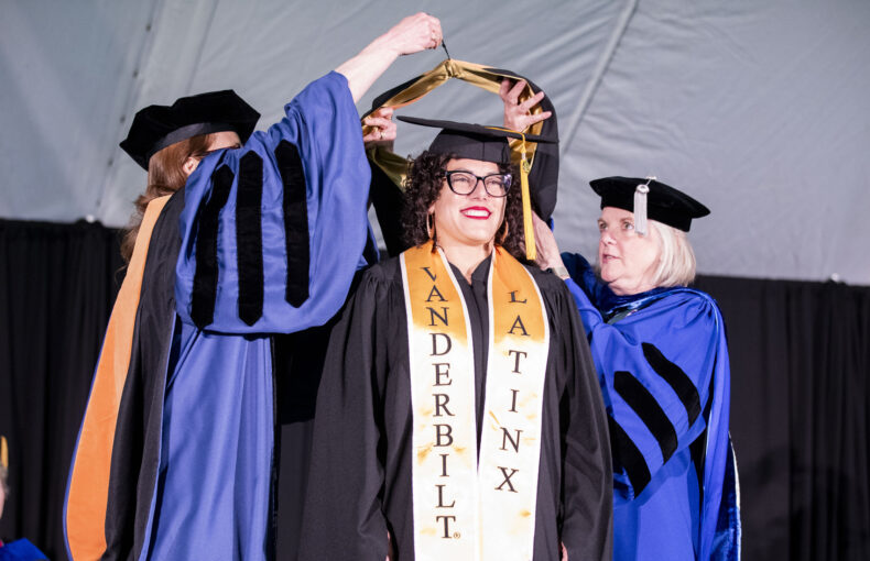 Nurse-Midwifery MSN graduate Vanessa Morales receives her hood. (photo by Susan Urmy)