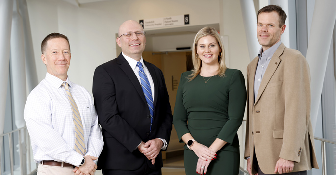 From left, Sean Collins, MD, MSc, Wesley Self, MD, MPH, Jessica Collins, program director, Vanderbilt Coordinating Center, and Matt Shotwell, PhD, play key roles in a now-international clinical trial platform that is investigating therapies aimed at reducing complications in patients hospitalized with COVID-19.
