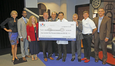 At Monday’s event, Hyundai Hope on Wheels representatives from Hyundai Motor America and local Hyundai dealerships presented Richard Ho, M.D., fourth from right, a grant award to further pediatric cancer research. (photo by Steve Green)
