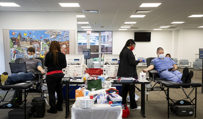 Employees make their donations at last week’s blood drive, held in Light Hall. (photo by Susan Urmy)