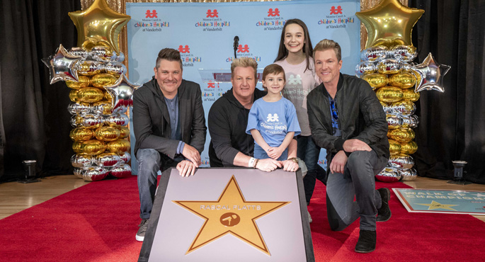 Award-winning vocal group Rascal Flatts, longtime supporters of Monroe Carell Jr. Children’s Hospital at Vanderbilt, received a star on the hospital’s Walk of Champions. Here, from left, the Rascal Flatts trio — Jay DeMarcus, Gary LeVox and Joe Don Rooney — pose alongside their new star with Children’s Hospital patients Caroline Lantz and Jessica Meyer.