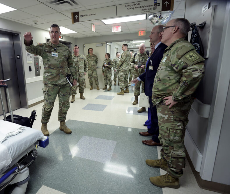 Christopher Bickett, MD, assistant professor of Emergency Medicine, and an AMCT3 member at VUMC, explains the operation of the Vanderbilt University Hospital Emergency Department for McQueen. (Photo by Donn Jones)