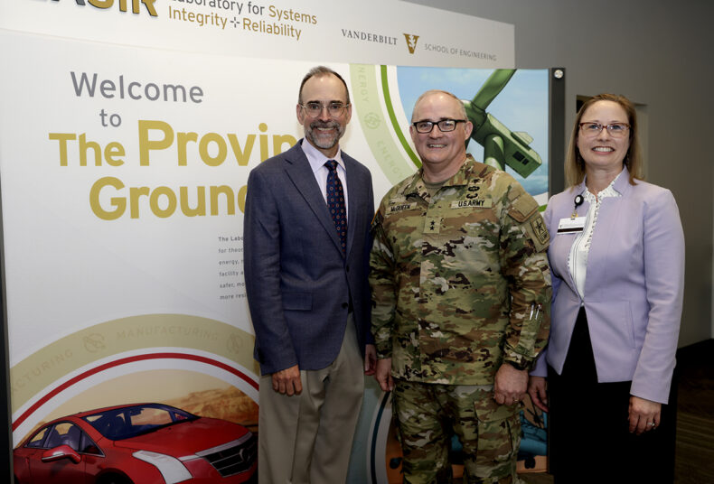 McQueen visited the LASIR (Laboratory for Systems Integrity and Reliability) Facility to learn more about the work there to measure the effects of shock waves on the brain and optic nerve. At left is LASIR founder and co-director Doug Adams, PhD, at right is Tonia Rex, PhD, professor of Ophthalmology & Visual Sciences. (Photo by Donn Jones)