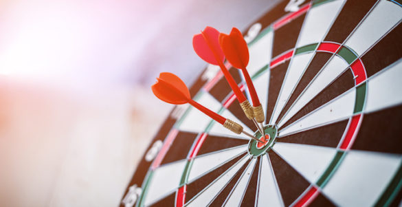 red three darts arrows in the target center