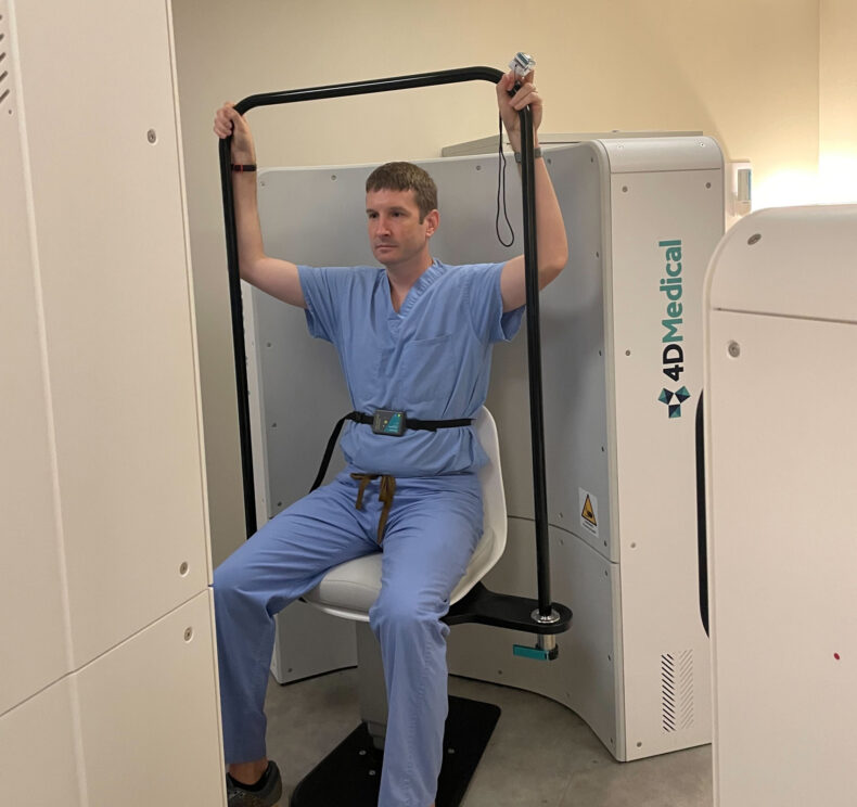 Bradley Richmond, MD, PhD, demonstrates receiving an X-ray with the new imaging system. 