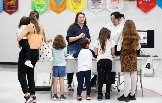 Lauren Gansereit and Iris Sun describe introduce young scientists-to-be to the wonders of the world of microbes. Gansereit is a research assistant and Sun a research technician in the laboratory of William Wan, PhD, assistant professor of Biochemistry.