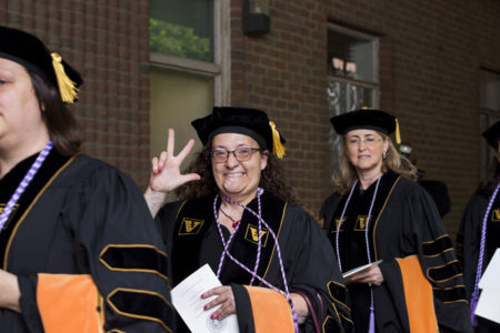 VUSN DNP graduates Danica Ninkovic, left, and Olive Phillips make their way to the main ceremony.