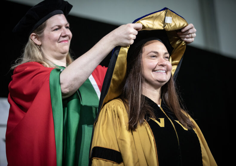 Fiona Harrison, PhD, hoods Rebecca Buchanan, receiving her PhD in Neuroscience. (photo by Erin O. Smith)