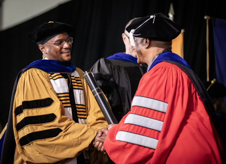 Hamilton David Green, receiving his PhD in Microbe-Host Interactions, accepts his diploma from C. André Christie-Mizell, Vice Provost for Graduate Education and Dean of the Graduate School. (photo by Erin O. Smith)