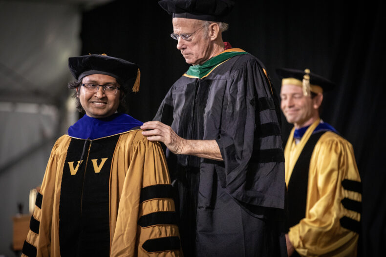 Md. Mirazul Islam, receiving his PhD in Cell and Developmental Biology, is hooded by Robert Coffey, MD. (photo by Erin O. Smith)