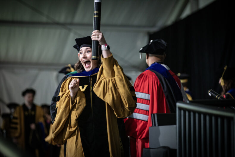 Mandy DeLanie Westland, receiving her PhD in Microbe-Host Interactions, celebrates after receiving her diploma. (photo by Erin O. Smith)