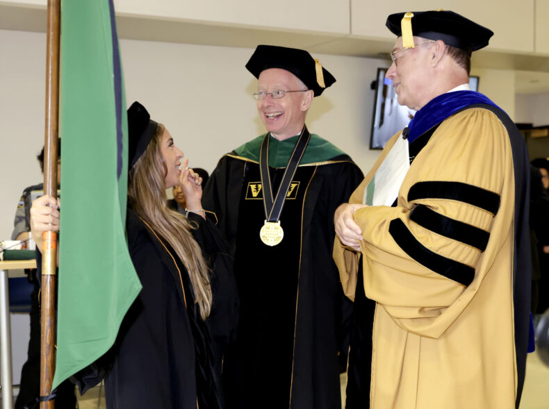 From left, Vanderbilt University School of Medicine 2025 class president Yanelis Diaz-Greenberg, MD, Don Brady, MD, and Jeff Balser, MD, PhD, share a moment before the Commencement ceremony’s procession of graduates begins. (photo by Donn Jones)