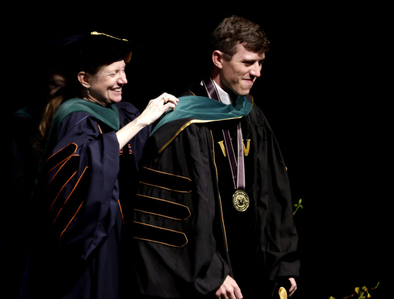 Carter Lovvorn, MD, recipient of the 2025 Founder’s Medal, receives his hood from Amy Fleming, MD, MScHPE. Lovvorn will complete his pediatrics residency at Monroe Carell Jr. Children’s Hospital at Vanderbilt. (photo by Donn Jones)