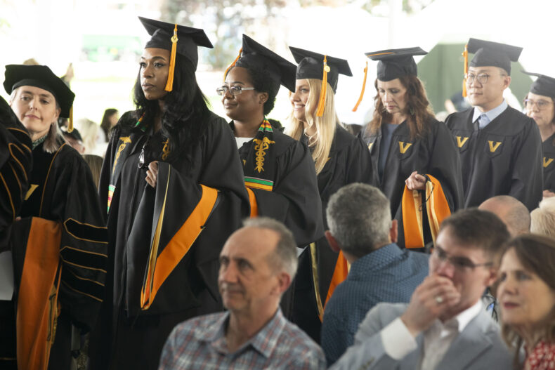 School of Nursing graduates process into the ceremony on Magnolia Lawn. (photo by Susan Urmy)