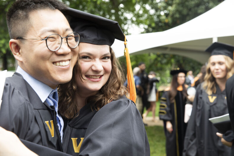 Brianna Schnvellet gives fellow Nursing School graduate Yuhao Hu a hug. (photo by Susan Urmy)
