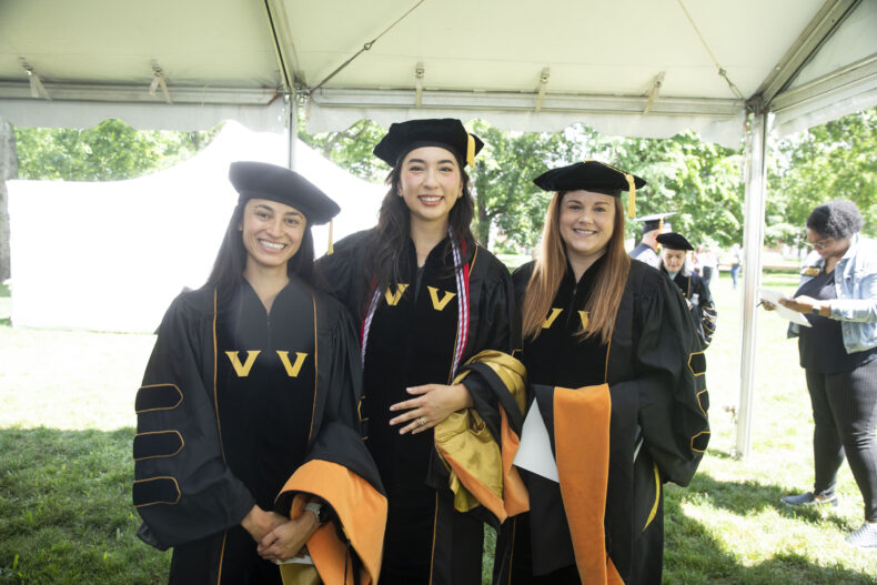 Lauren Mattiace, left, Victoria Smith and Ashley Tuttle, at at the School of Nursing ceremony on Magnolia Lawn. (photo by Susan Urmy)