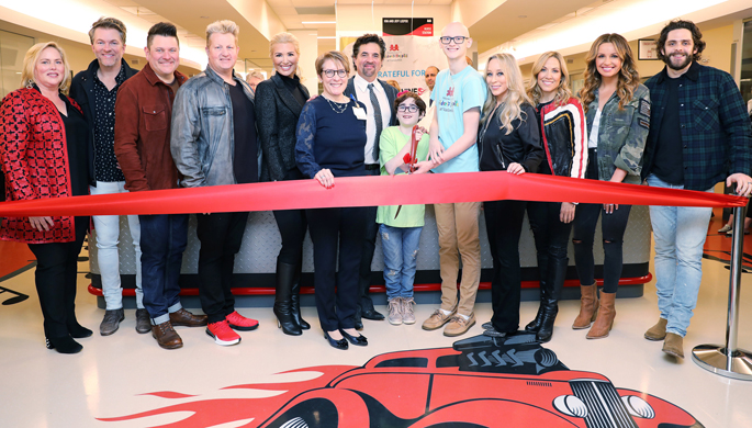 From left, Kathryn Carell Brown, Joe Don Rooney, Jay DeMarcus and Gary LeVox of Rascal Flatts, Allison DeMarcus, Meg Rush, MD, MMHC, Scott Borchetta, Maddie Wright, Dalton Waggoner, Sandi Spika Borchetta, Sheryl Crow, Carly Pearce and Thomas Rhett prepare for the ribbon cutting of the Big Machine Neighborhood on the new 11th floor at Children’s Hospital.