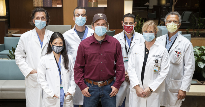 Liver transplant donor Sam Burnett with surgical team members, from left, Lee Gordon, MD, Lea Matsuoka, MD, Sophoclis Alexopoulos, MD, Martin Montenovo, MD, Ahlie Kerr, RN, and Joseph Awad, MD. 