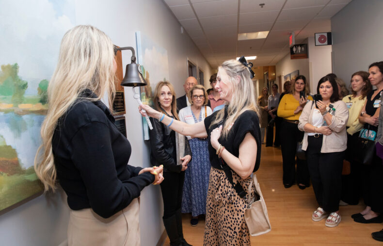 Suzanne Duckworth rings the bell in honor of her husband, Matt Duckworth. (photo by Susan Urmy)