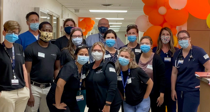 The “orange team,” led by Buddy Creech, MD, director of the Vanderbilt Vaccine Research Program, assembles in the old Clinical Research Center space in Medical Center North on the first day of the phase 3 Moderna vaccine study this summer.