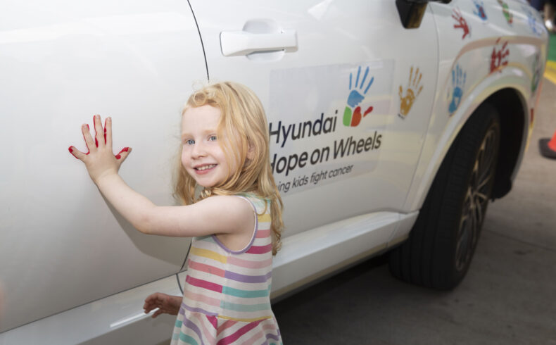 Greta Ford places her handprint on the Hyundai Palisade vehicle as part of the Hyundai Hope on Wheels event at Monroe Carell Jr. Children's Hospital at Vanderbilt. (photo by Susan Urmy)