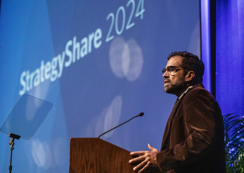 Del Ray Zimmerman, director of the Program for LGBTQ Health and Office for Diversity Affairs, and member of the StrategyShare 2024 Committee, introduces a presentation. (photo by Erin O. Smith)