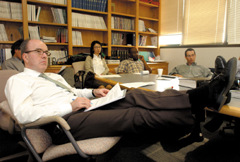 Wood thinks fast, eats fast and walks fast, but in lab meetings he’s likely to prop up his well-traveled feet … (photo by Dana Johnson)