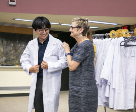 Cynthia Gadd, PhD, MBA, director of Graduate Studies for the program in Biomedical Informatics, congratulates new graduate student Eugene Jeong.