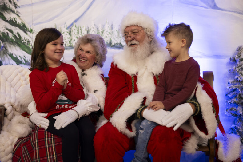 Kennedi Austin, 6 and her brother, Owen Austin, 5, visit with Santa and Mrs. Claus. (photo by Erin O. Smith)
