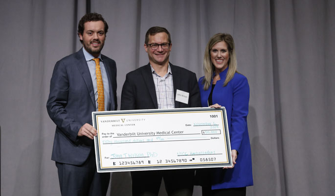  John Wilson, PhD, center, assistant professor of Chemical and Biomolecular Engineering at Vanderbilt University, received a $50,000 research grant at the 2019 Vanderbilt-Ingram Cancer Center Ambassador Breakfast after delivering the winning pitch on his project “Engineering Smart Technologies for Cancer Immunotherapy.” Pictured with Wilson are VICC Ambassadors Hank Ingram and Sydney Ball.