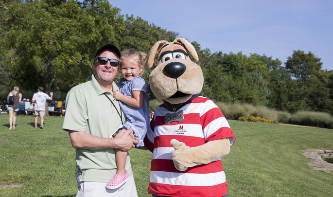 Families recently gathered for the annual Arrington Vineyards Harvest Party. The event, now in its eighth year, again benefited Monroe Carell Jr. Children’s Hospital at Vanderbilt. New this year, proceeds supported neonatology training and research. The daylong Harvest Party, sponsored by Delta Dental of Tennessee and Pinnacle Bank, featured food, drinks and a concert by country music star and Arrington Vineyards co-owner Kix Brooks. Shown here are Troy Turek and his daughter, Olivia, enjoying the day with Champ.