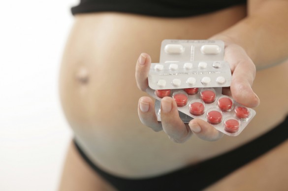 Pregnant Woman Holding Pills