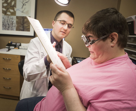 Joshua Robinson, OD, works with patient Melanie Oliver during a recent low-vision appointment.