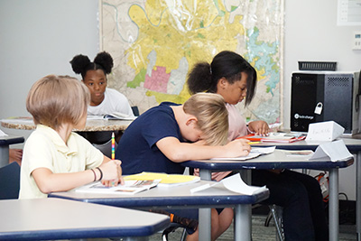 student with head down on desk
