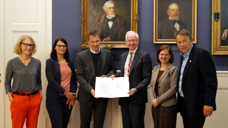 From left, Vanessa Tatum, manager of International Partnerships at Charité, Anna van Santen, MD, director of International Affairs at Charité, Charité Dean Joachim Spranger, MD, Donald Brady, MD, Executive Vice President for Educational and Medical Staff Affairs at VUMC and Executive Vice Dean for Academic Affairs at Vanderbilt University School of Medicine, Marie Martin, PhD, MEd, Assistant Dean of Global Health Education at Vanderbilt University School of Medicine and Associate Vice President of Global Initiatives for VUMC, and Charité Chief Executive Officer Heyo Kroemer, MD, with the signed memorandum of understanding. Photo provided by Charité – Universitätsmedizin Berlin.